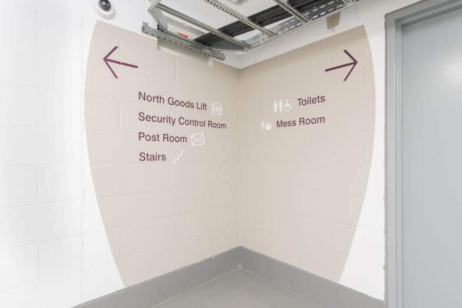Large scale directional signs painted directly on the wall in the 20 Fenchurch St offices basement